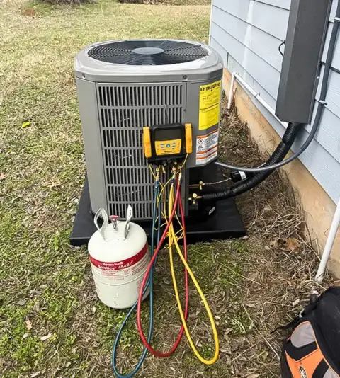 Adding refrigerant to this HVAC unit during a routine bi-annual tune up.