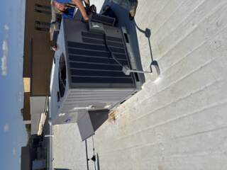 Cool Co technicians performing quality check on new Carrier system