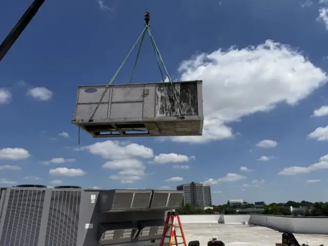 Cool Co removing old and unclean system via crane. 