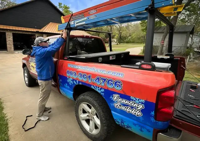 The owner of Cool Co Heating & Air Conditioner prepares the service truck.