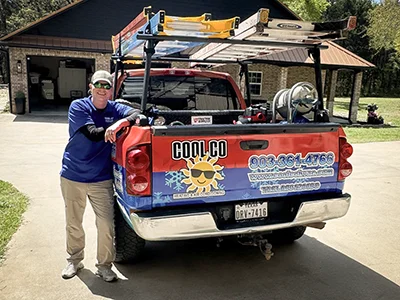 Owner of Cool Co HVAC, Shane Stone, standing with his service truck.
